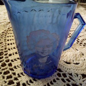 Cream pitcher with Shirley Temple on it.